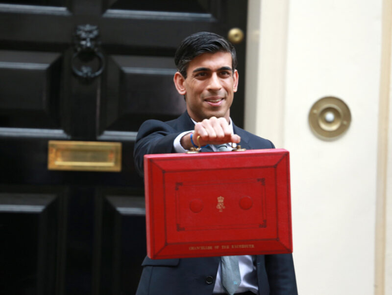 The Chancellor holding the red budget box