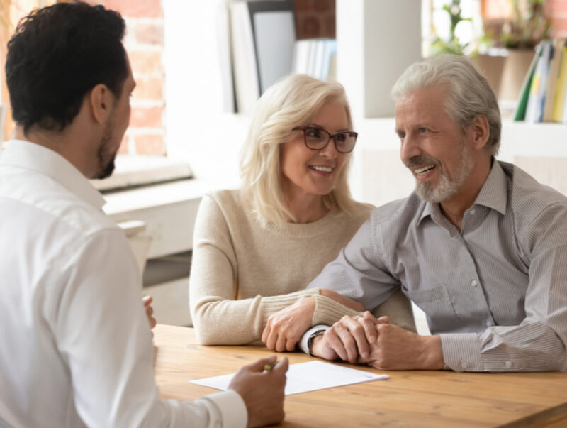 An older couple speaking with a financial advisor