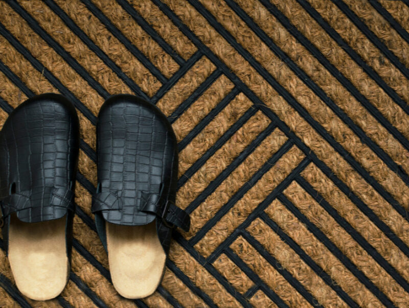 A pair of slippers on a doormat
