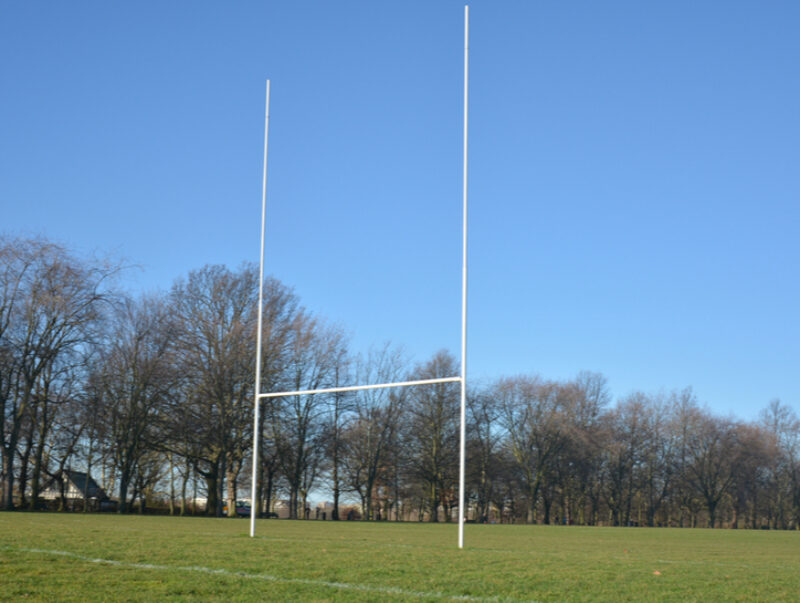 Rugby posts against a clear blue sky
