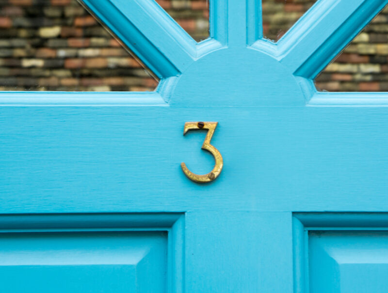 A blue door with a number 3 on it