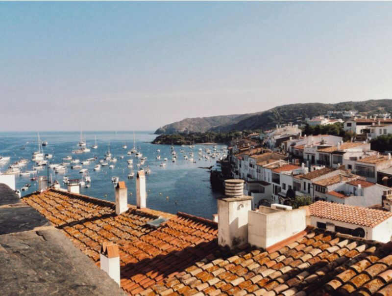 A Spanish seaside town with boats in the harbour